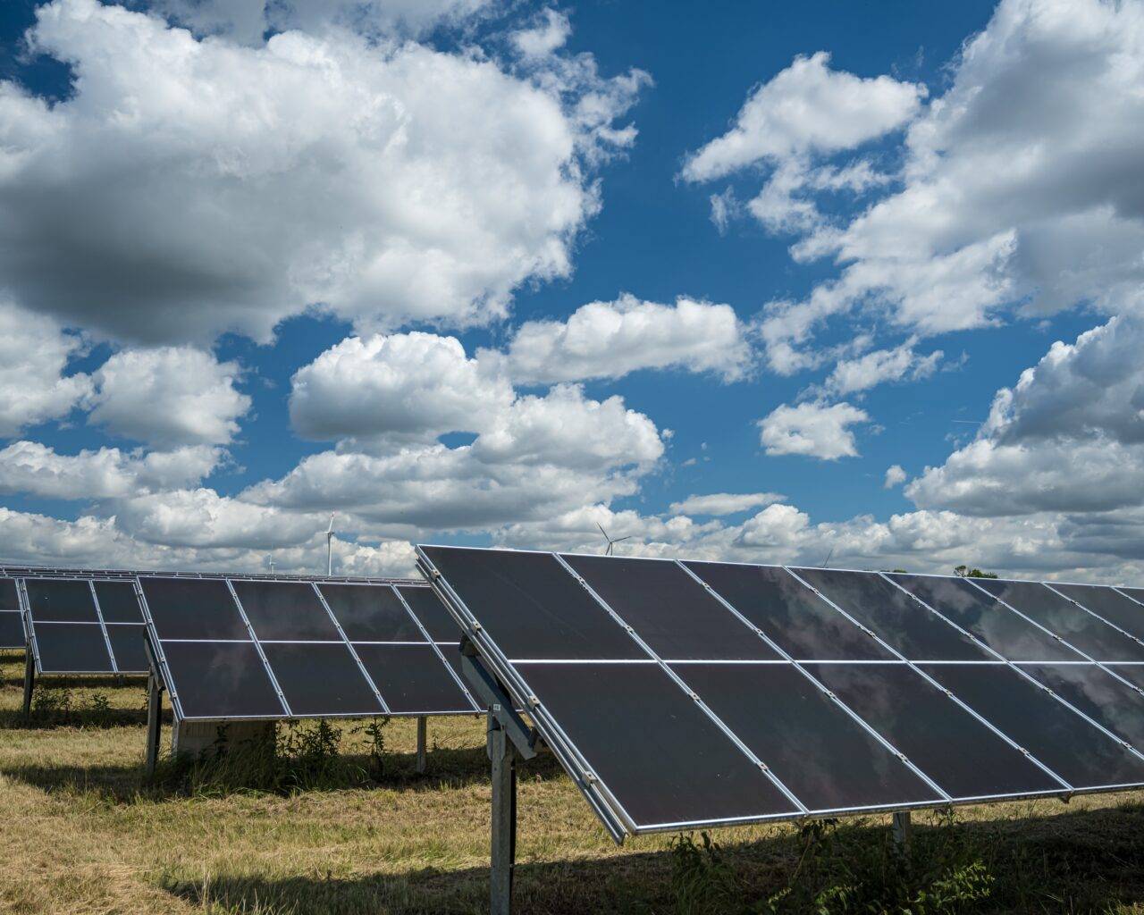 Solar panels used for renewable energy on the field under the sky full of clouds